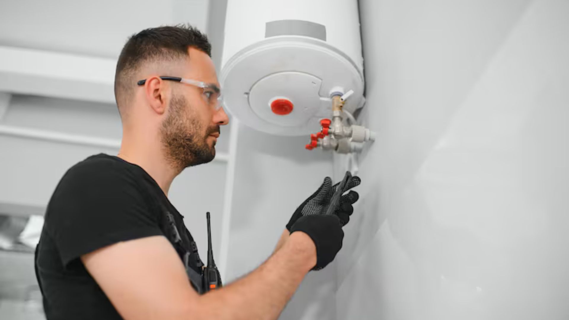 Plumber repairing a residential water heater in Longmont, CO